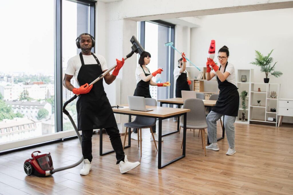 Workers with equipment for cleaning on background of modern office.